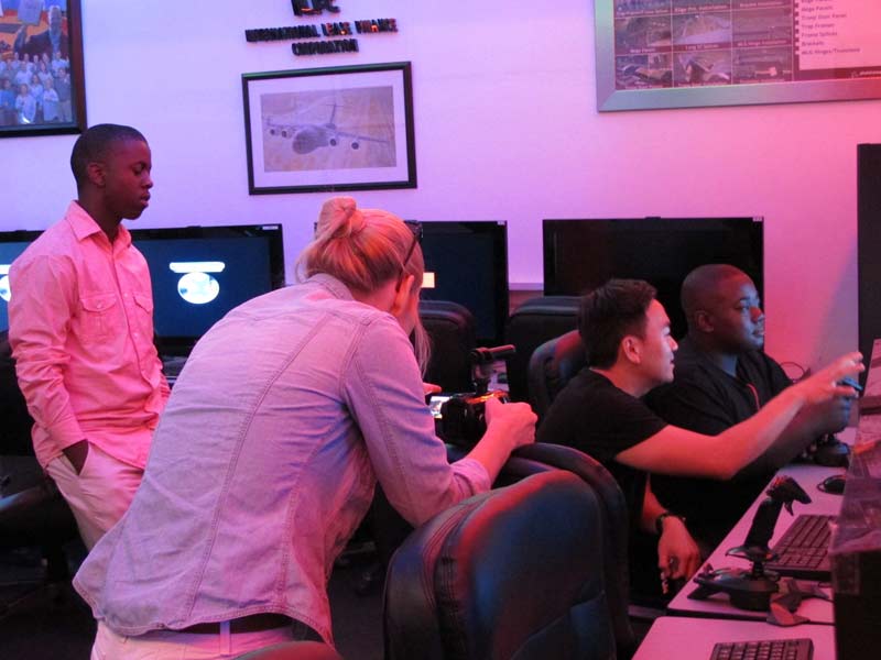 TAM participants learning to fly using flight simulator programs.