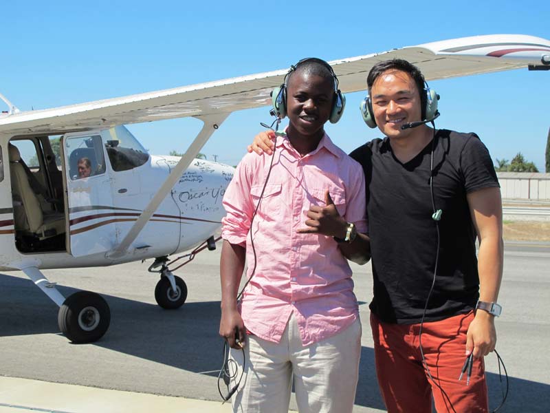 James Knox and Toan in front of an airplane.