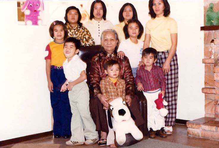 Family photo with Toan holding dog stuffed animal