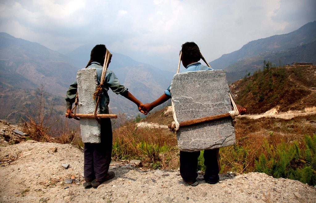 Children in Nepal carrying stones on their backs