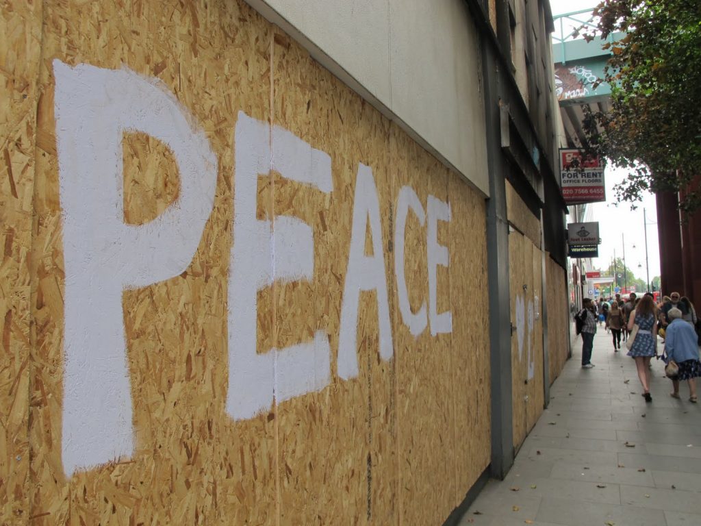 "Peace" written on boarded-up stores during the 2011 London riots.