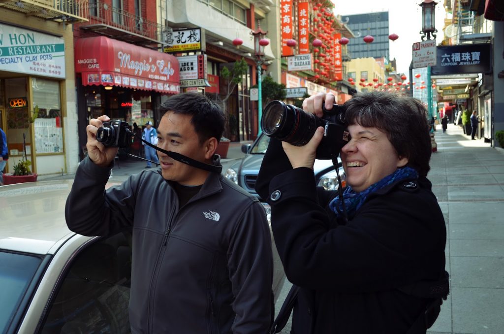 Toan Lam and Kat Sloma taking pictures in Chinatown