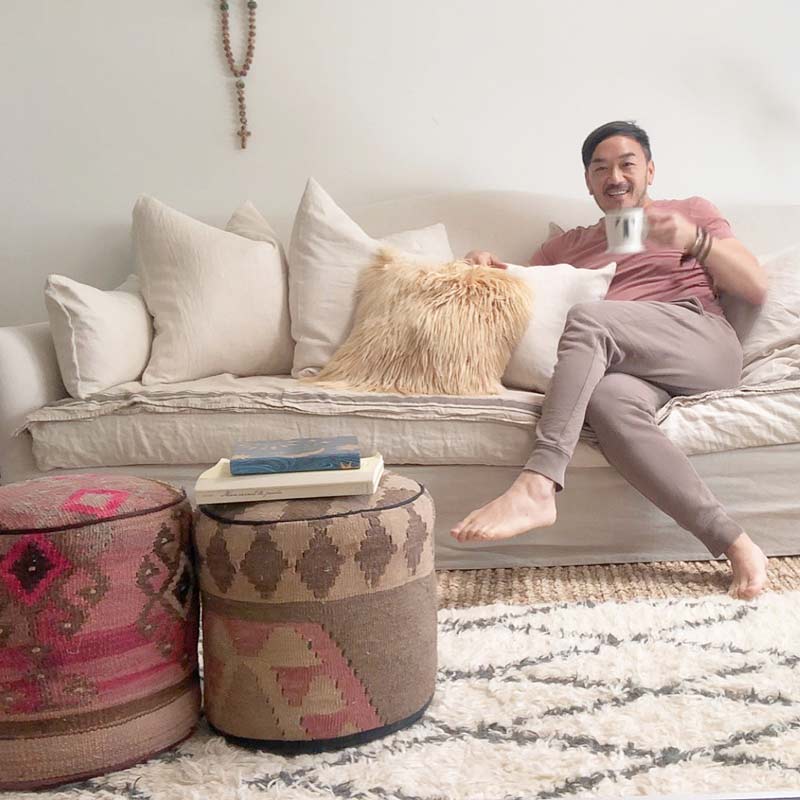 Toan and his new sofa with pillows he custom designed.